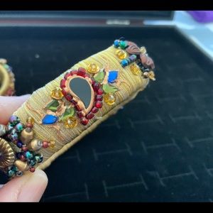 Handmade boho style bangle with thread and colored beads.